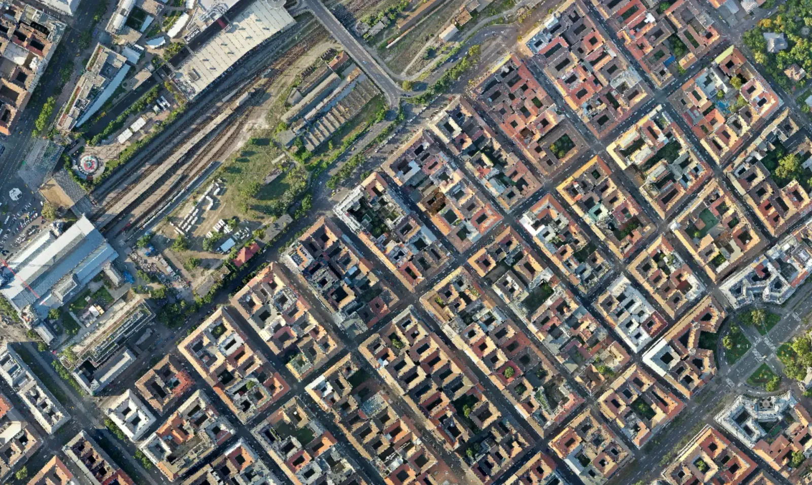 Dense urban orthomosaic at a few centimetres per pixel, with roof lines and streets sharp enough to trace
